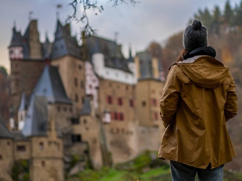 Woman looking at Eltz medieval historic castle, Wierschem, Rhineland-Palatinate, Germany.