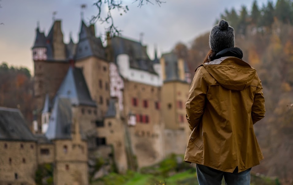 Woman looking at Eltz medieval historic castle, Wierschem, Rhineland-Palatinate, Germany.