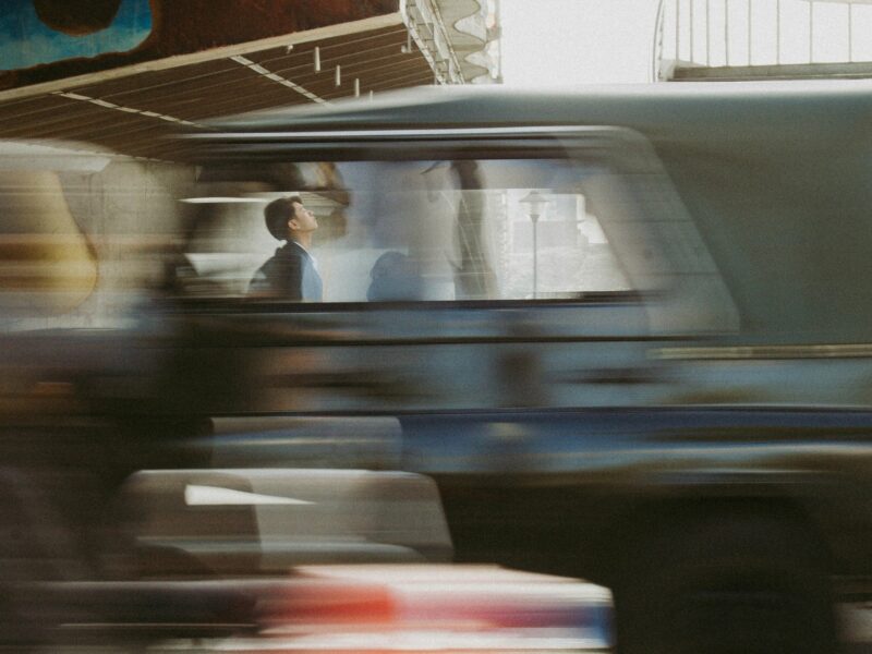 A blurry photo of a man driving a truck