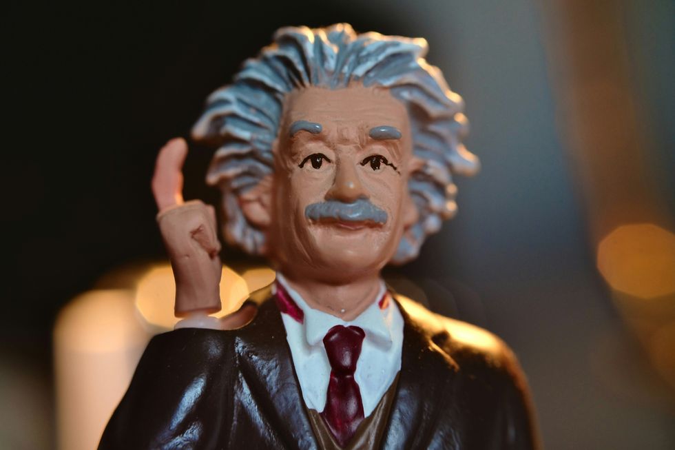 A closeup shot of a small toy Albert Einstein figurine