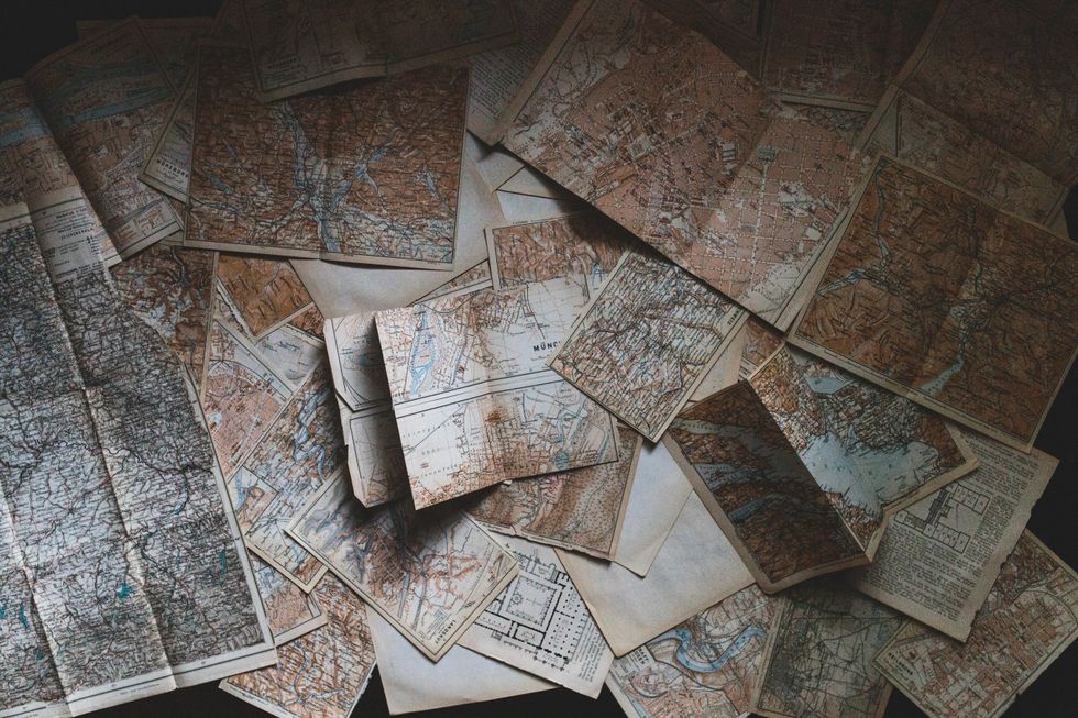 A collection of vintage maps, reflecting the traditional methods of navigation and exploration.