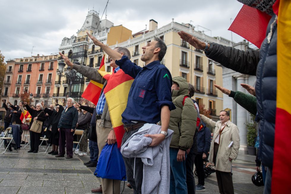 A group of far-right protesters perform the fascist salute during a rally in Madrid.
