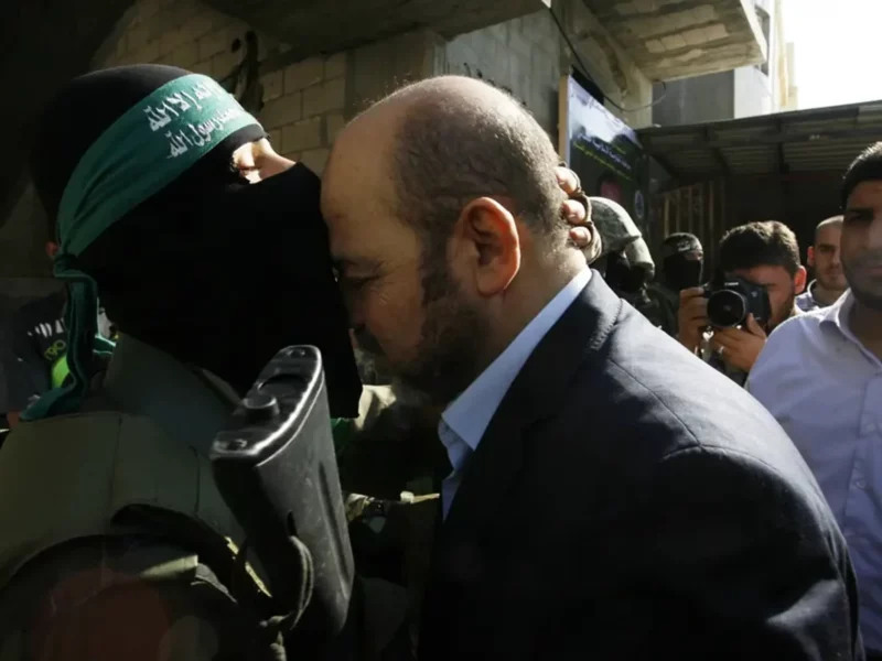 A Hamas militant kisses the head of Hamas political leader Moussa Abu Marzouk