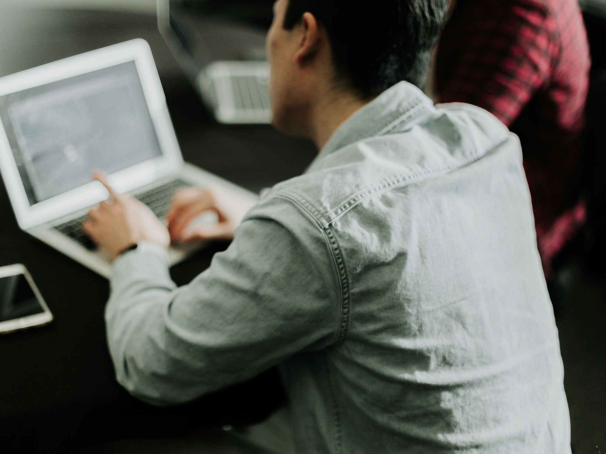 A man types at a computer