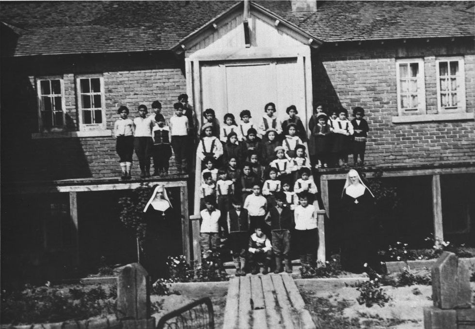 Children and nuns in front of the Indian Residential School, Maliotenam, Quebec, circa 1950