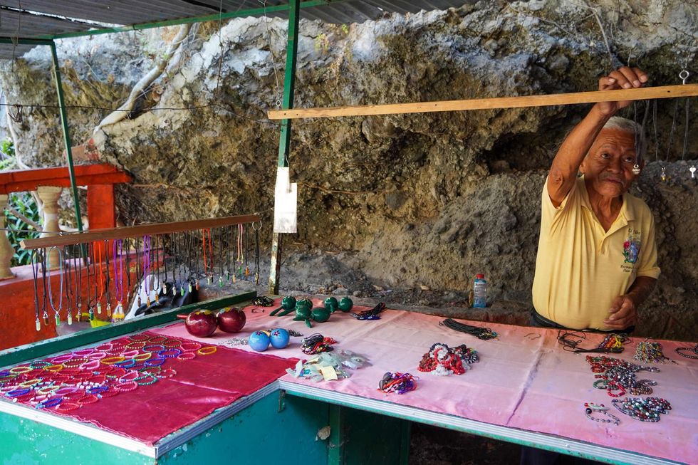 David Pineda, 83, sells handmade maracas near El Salto de San Antón waterfall. He has been fighting to conserve the site for 30 years.