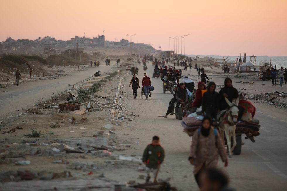 Displaced Palestinians return to their destroyed homes.