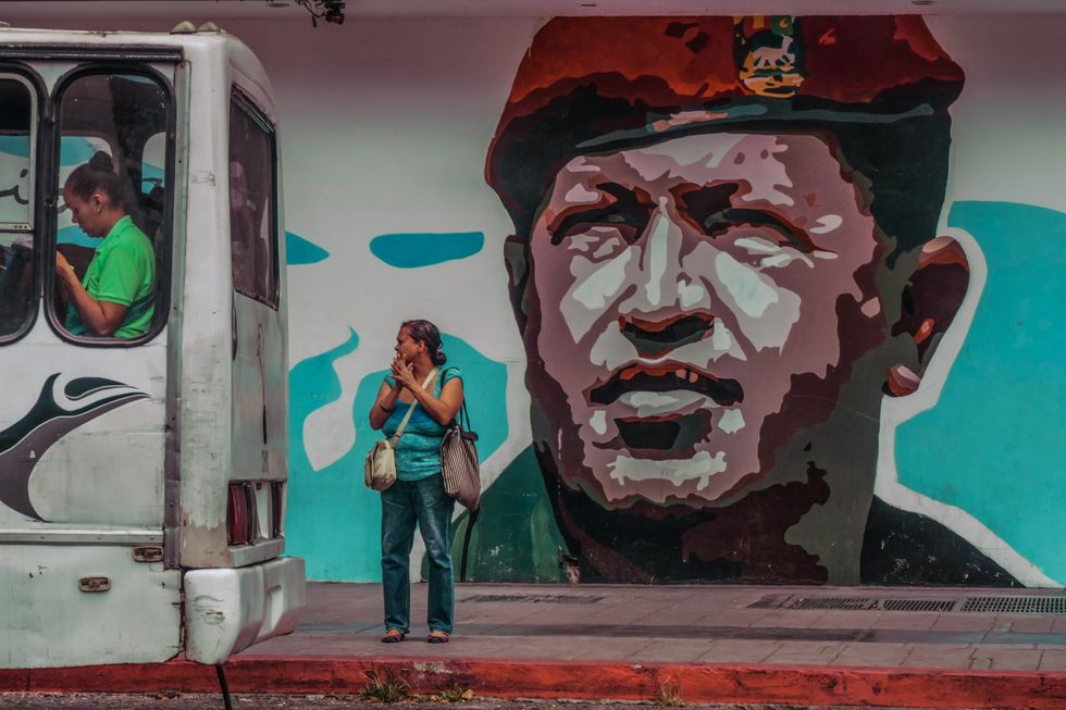 ​ A graffiti wall with a painting of the former Venezuelan president Hugo Chávez seen in Caracas.