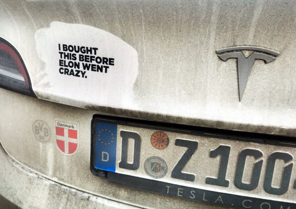 ​Anti-Musk sticker that reads "I bought this before Elon went crazy" on a German car