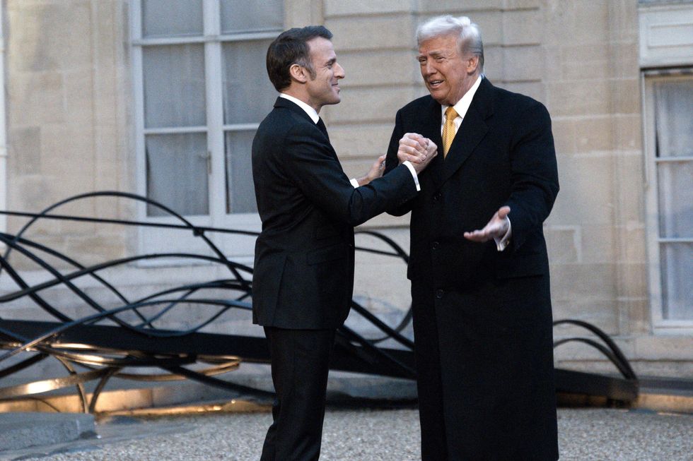 France's President Emmanuel Macron welcomes US president-elect Donald Trump before a meeting at The Elysee Presidential Palace in Paris