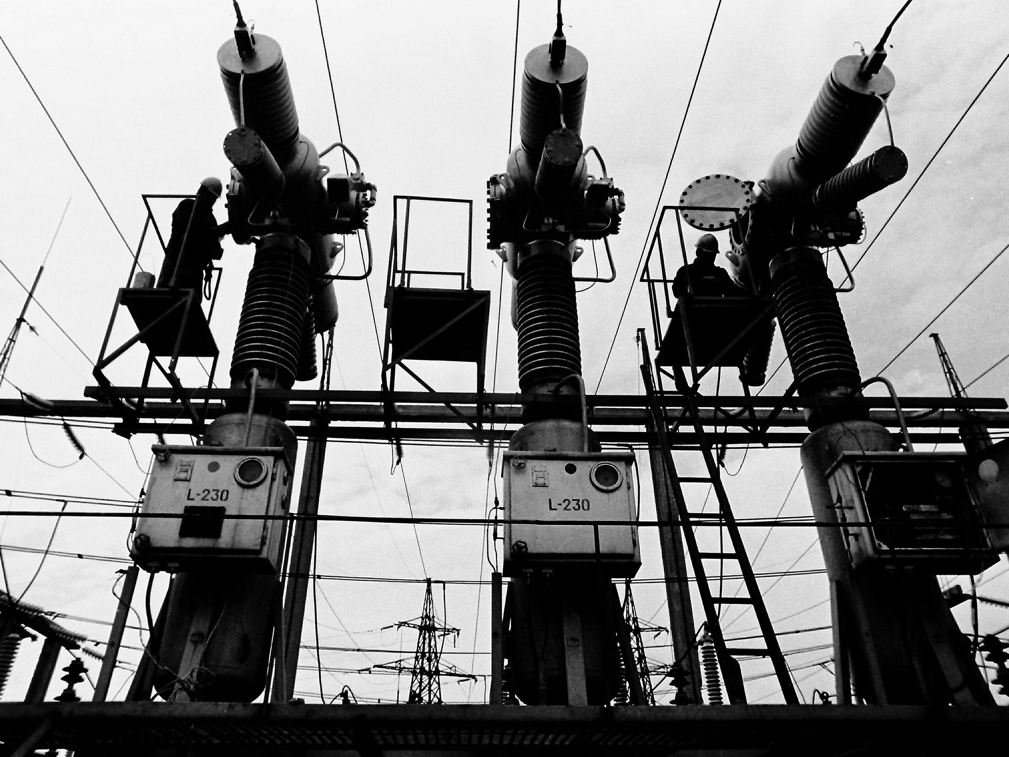 High-voltage electrical substation in the Riga microdistrict. Specialists in high-voltage installation of electrical networks work.