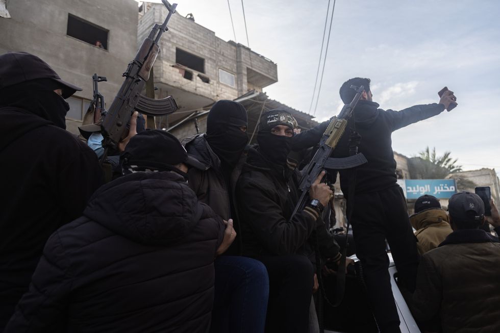 Members of the Palestinian resistance factions celebrate in the streets of the city of Khan Yunis in the southern Gaza Strip after the ceasefire between Israel and Hamas, which lasted for 470 days