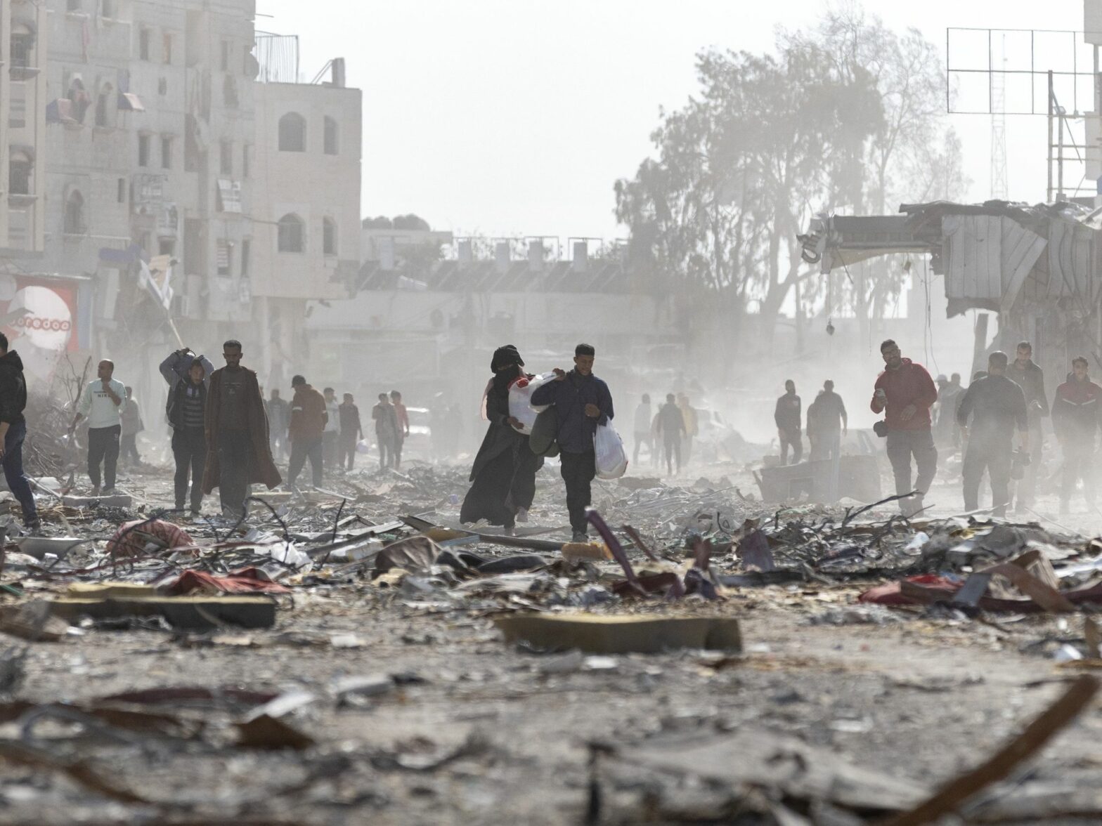 Palestinian citizens inspect their destroyed homes in the city of Rafah, south of the Gaza Strip, after the ceasefire came into effect