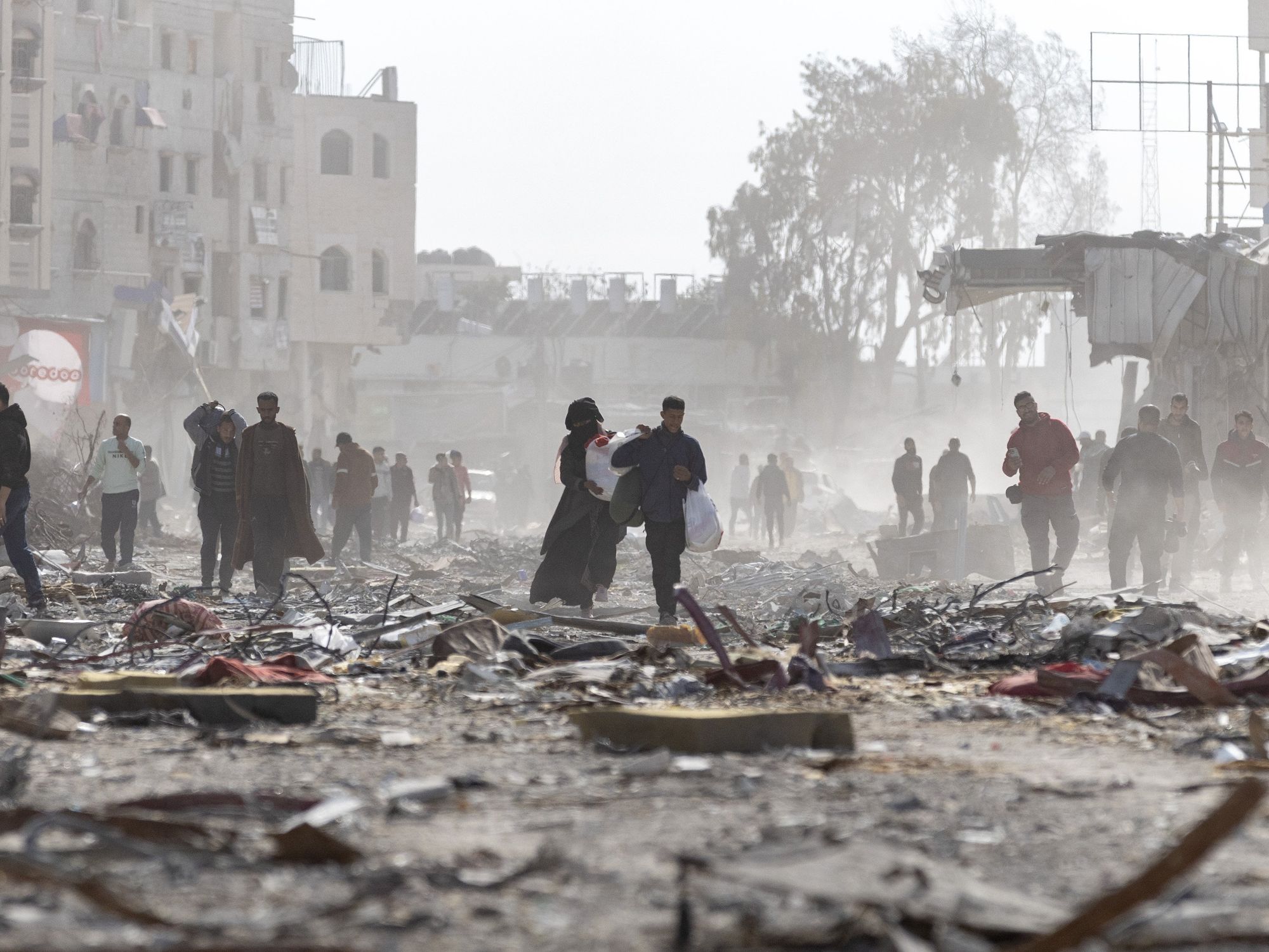 Palestinian citizens inspect their destroyed homes in the city of Rafah, south of the Gaza Strip, after the ceasefire came into effect