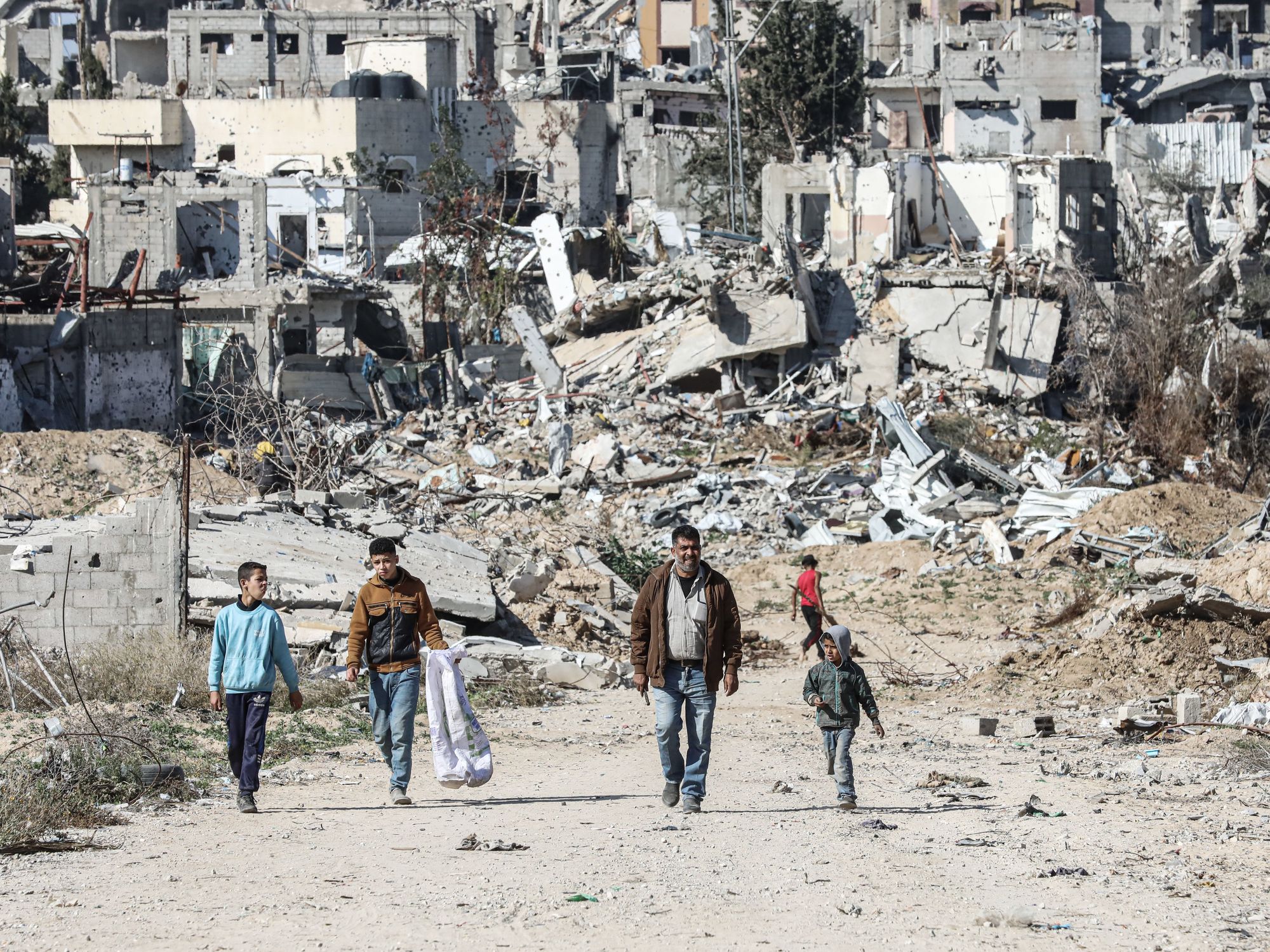 Palestinian Territory: Displaced Palestinians continue to return their houses past heavily damaged and partially collapsed buildings after the ceasefire and hostage-prisoner swap deal between Hamas and Israel at Bureij refugee camp in Deir al-Balah