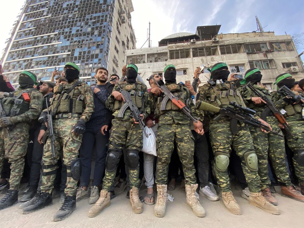 Palestinians gather near the site of the handover of the Israeli hostages to the International Committee of the Red Cross (ICRC) during the hostage-prisoner exchange operation in Saraya Square in western Gaza City