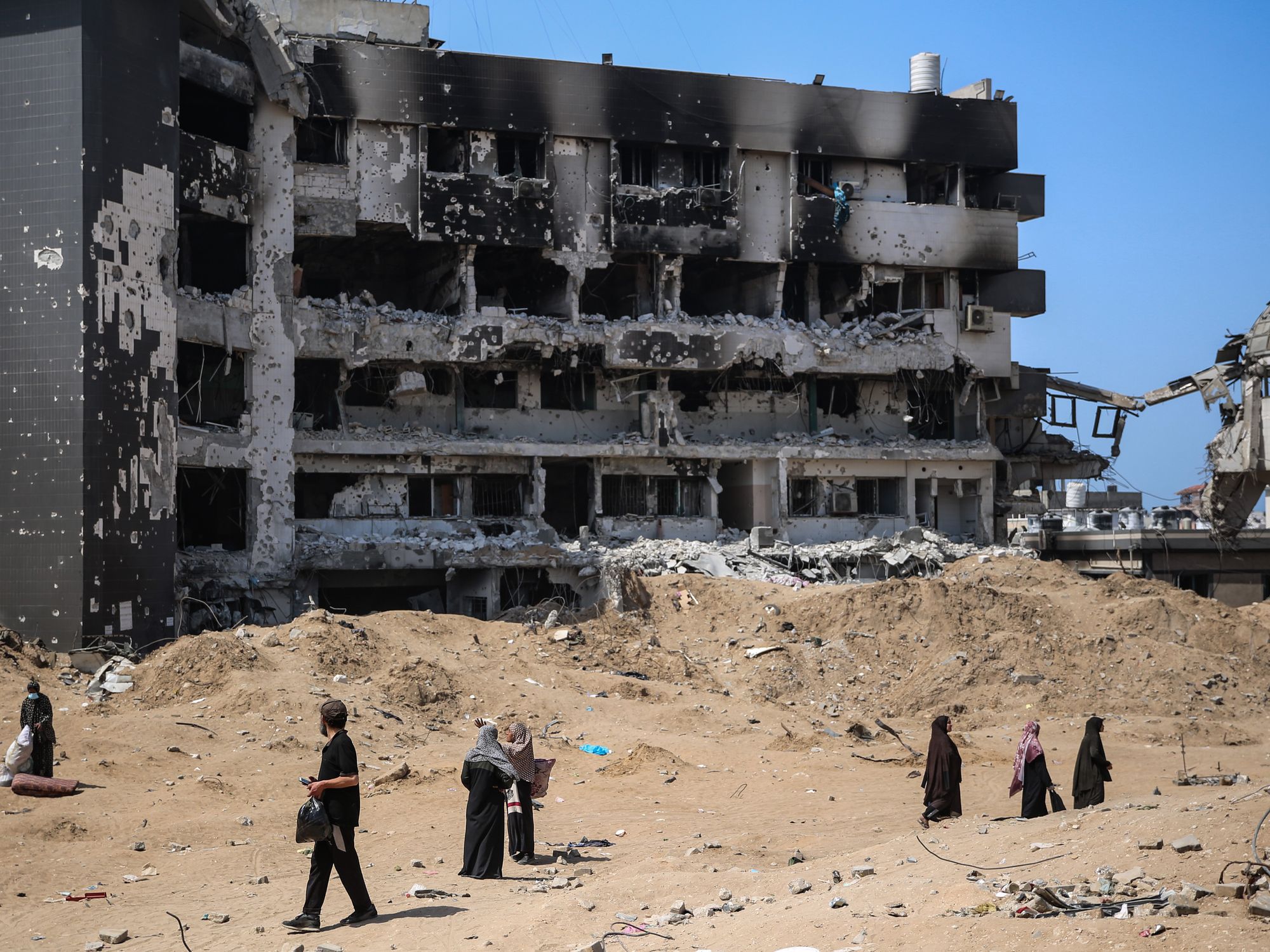 Palestinians inspect the damage at al-Shifa Hospital complex, following a two-week military operation by the Israeli army in Gaza City