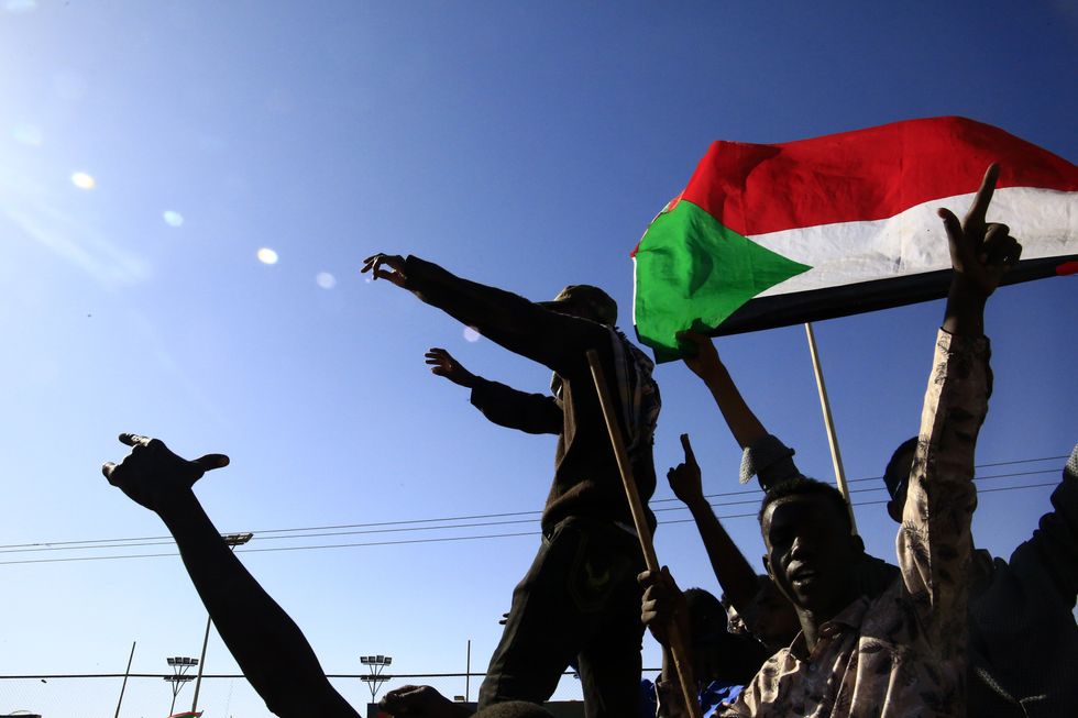 People celebrating the Sudanese army's retaking of Wad Madani