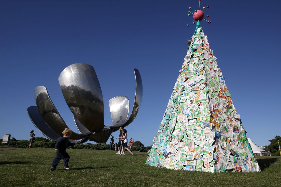 People walk at the ''Christmas park'' on Plaza de las Naciones Unidas in Buenos Aires, Argentina.