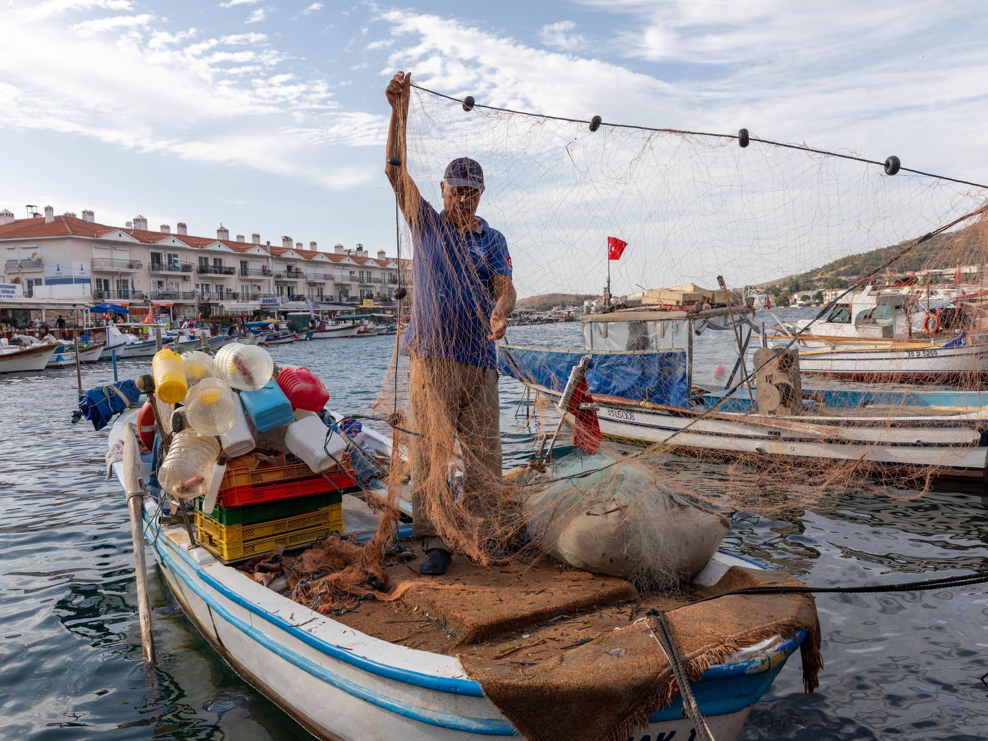 Photo of a man handling a fishing net near Izmir, Turkey
