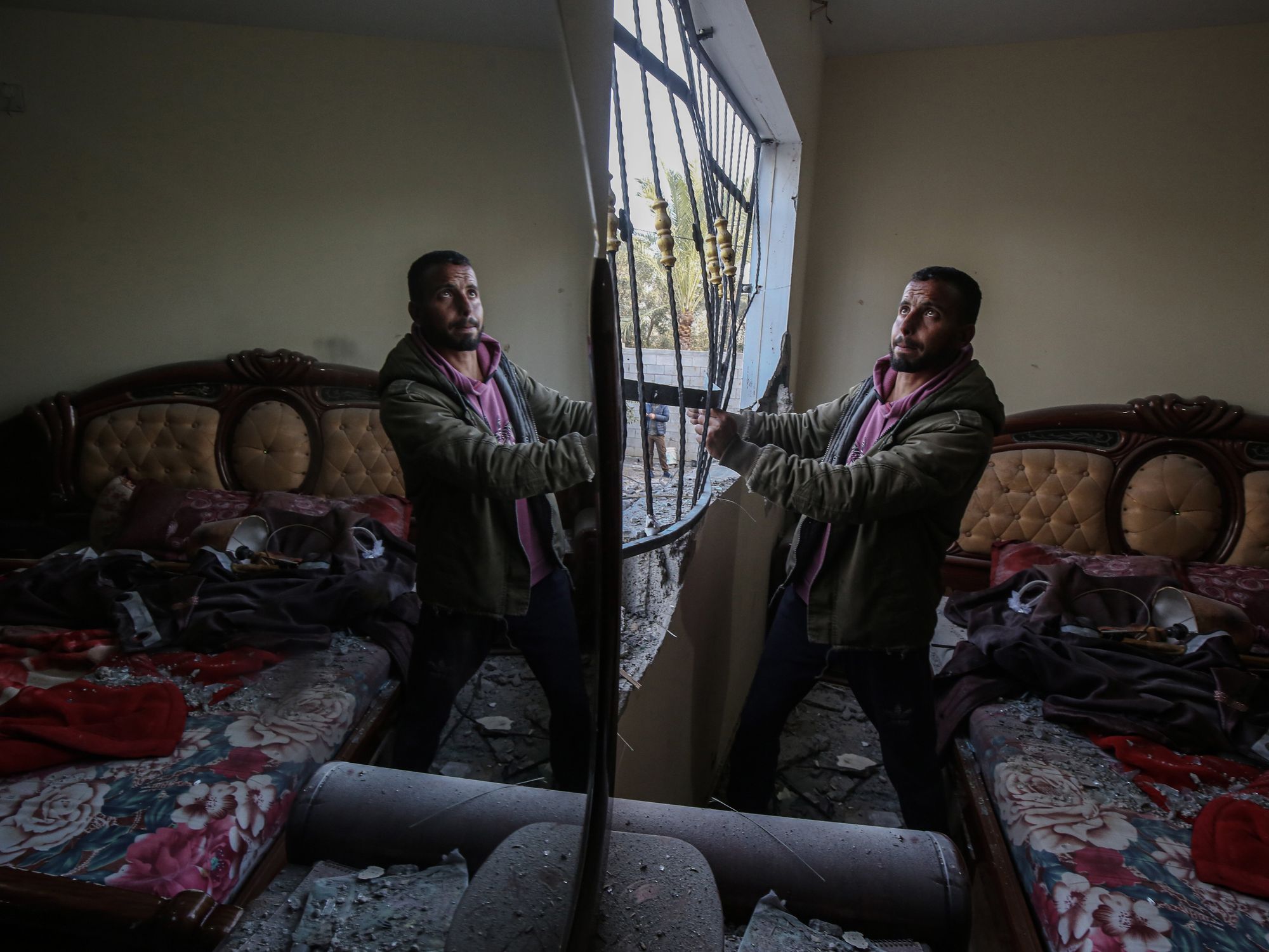 photo of a man looking at the mirror.
