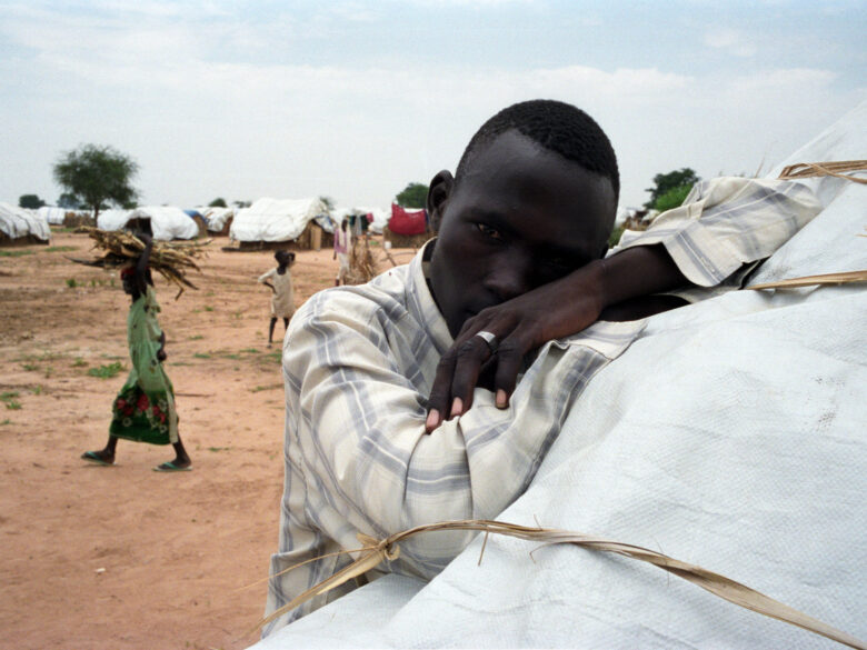 Photo of a man reclining in a tent in Nyala, Darfur, Sudan