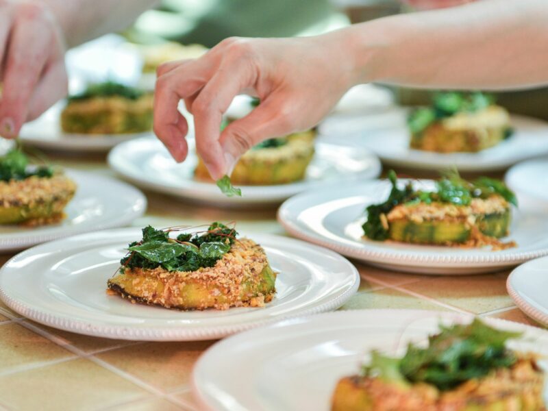 Photo of a person dressing plates