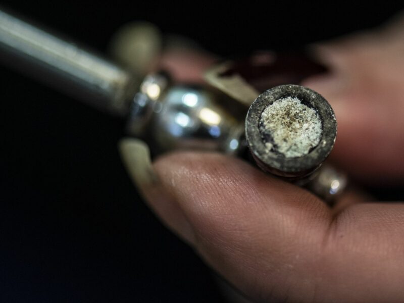 Photo of a person handlig a crack pipe
