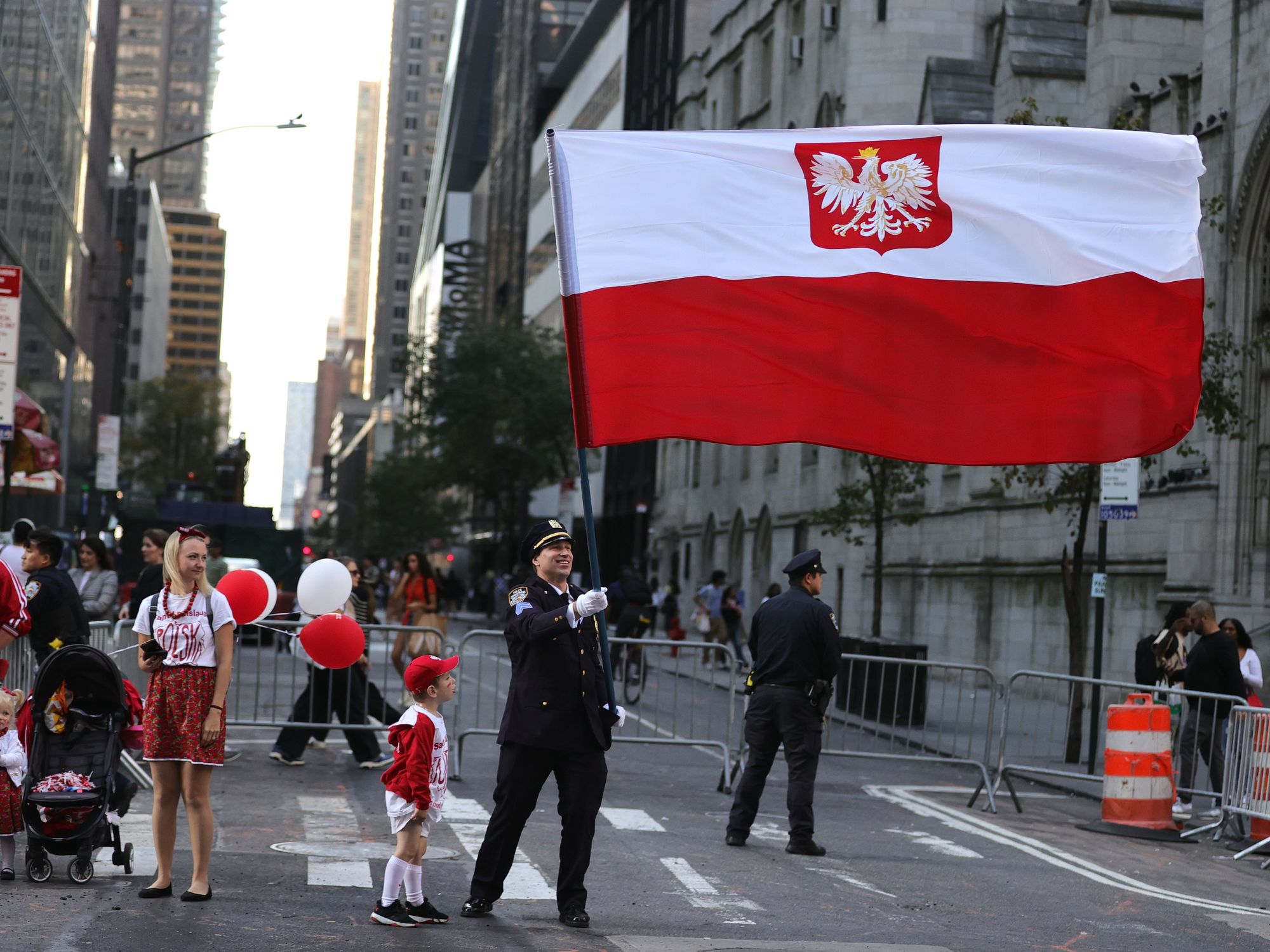photo of a police officer holding a big polish flag