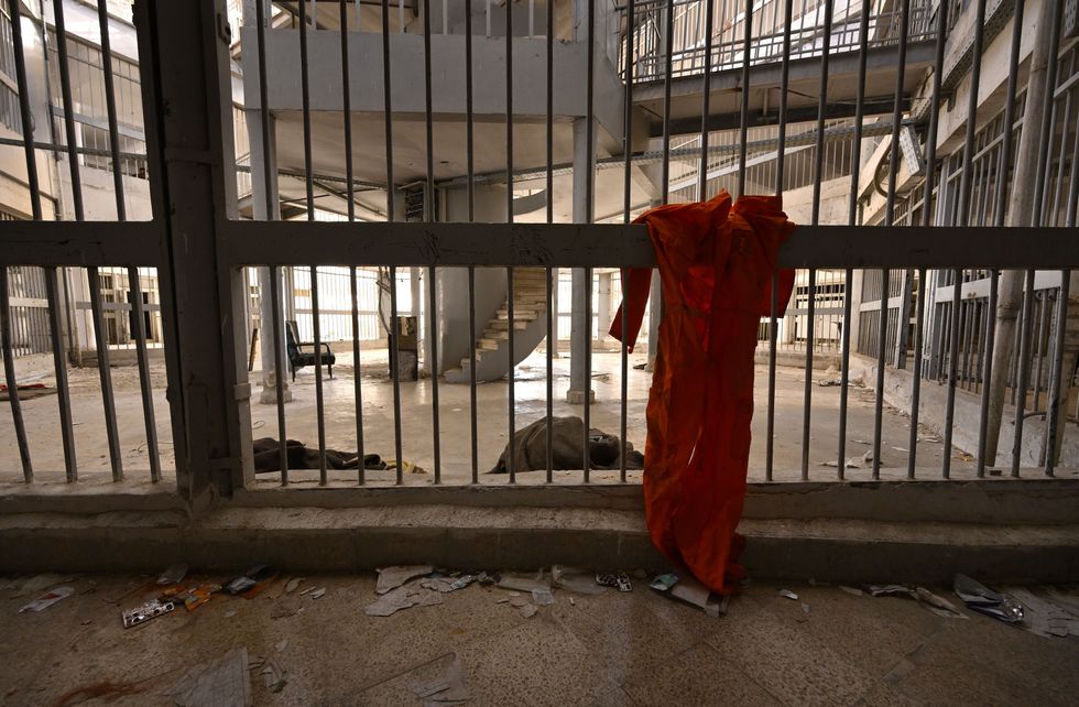photo of a prison with a hanging orange jumpsuit