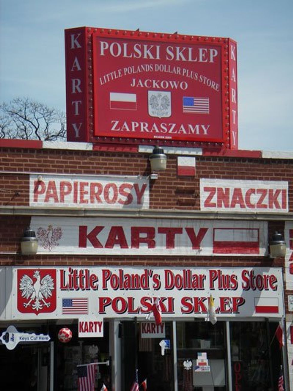 photo of a red and white polish store with polish and american flags.