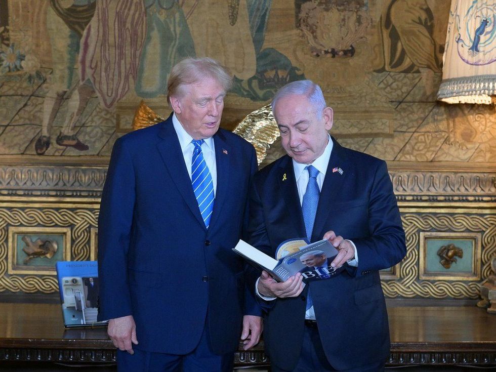 Photo of Donald Trump reading over Benjamin Netanyahu's shoulder at Mar a Lago, Florida, in July 2024