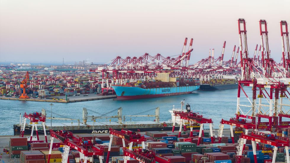 photo of ​A cargo ship loads containers at the Qianwan container terminal of Qingdao Port, eastern China.