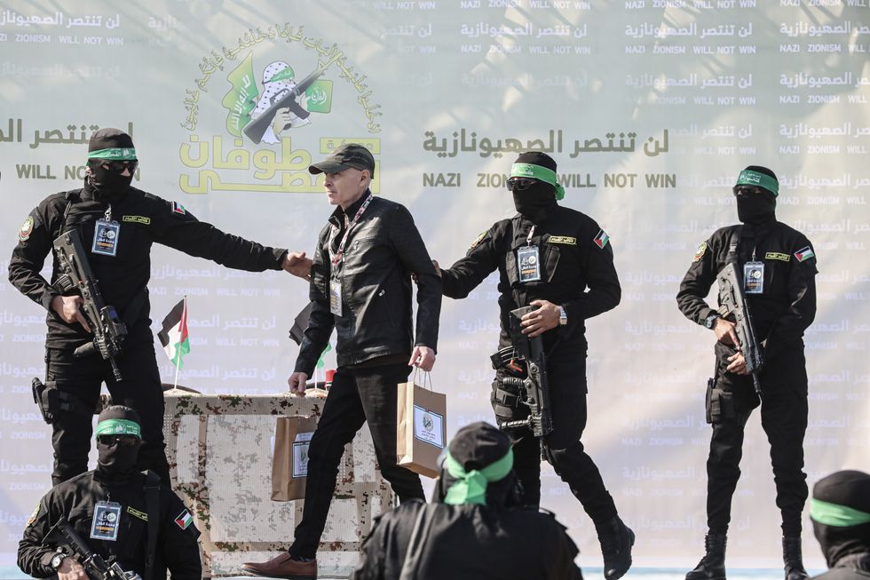 photo of Israeli hostage Keith Siegel being delivered to the Red Cross by Hamas fighters in Gaza City on Feb.1.