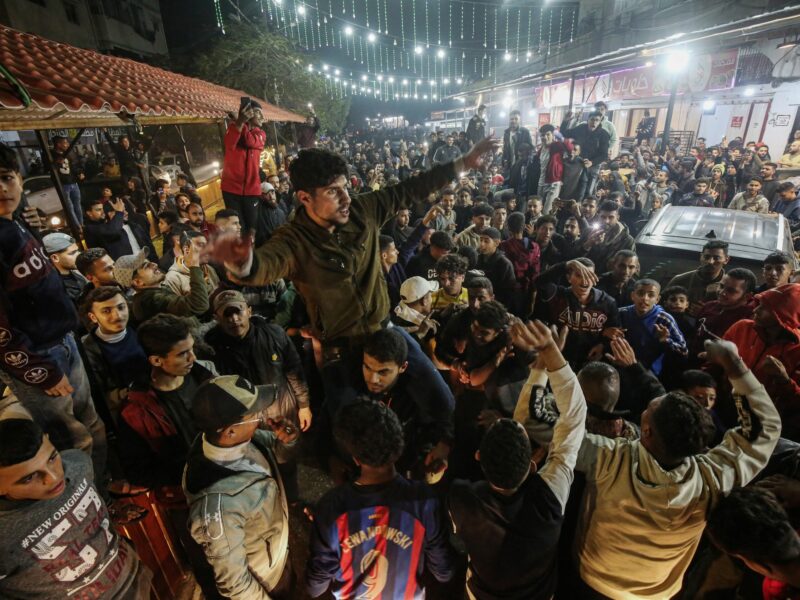 Photo of Palestinians rejoicing at news of a ceasefire agreement with Israel, in Deir al Balah, central Gaza, on Jan. 15