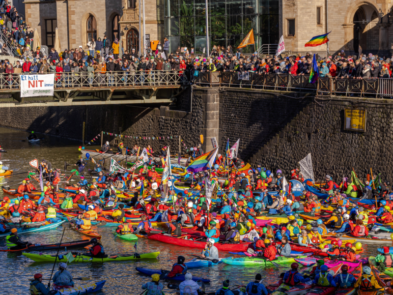 Photo of people on boats, kayaks, and canoes joining a pro-democracy and diversity demonstration in Cologne, part of nationwide protests against the rise of far-right parties in Germany.