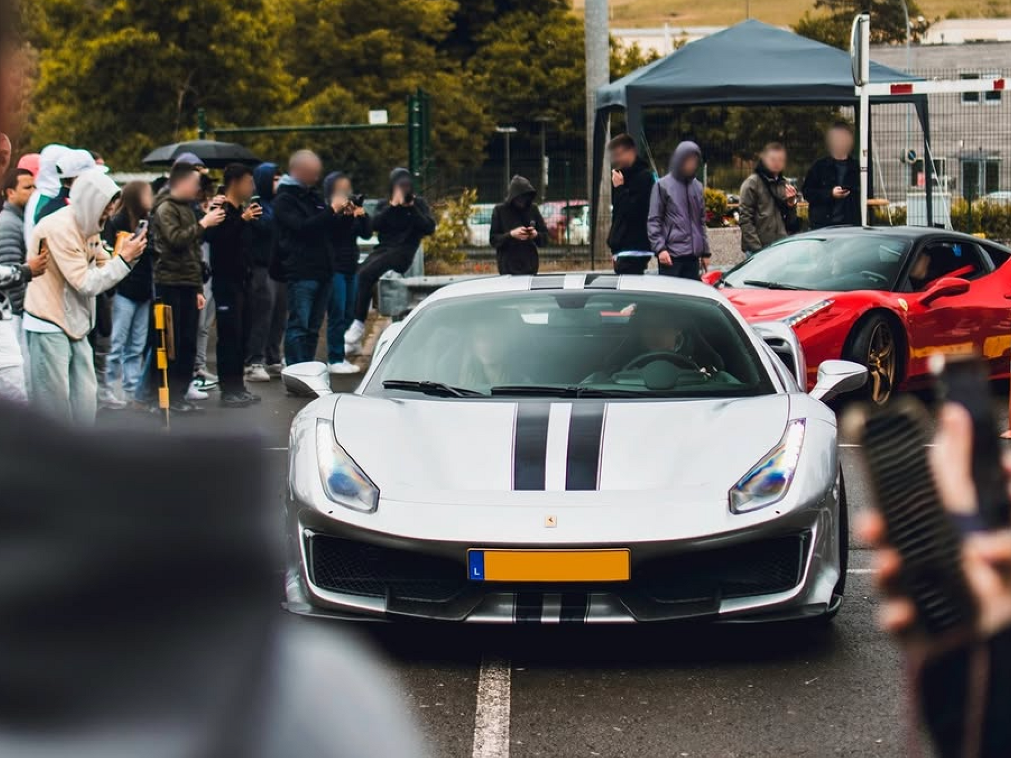 Photo of people taking pictures of Ferrari supercars in Luxembourg
