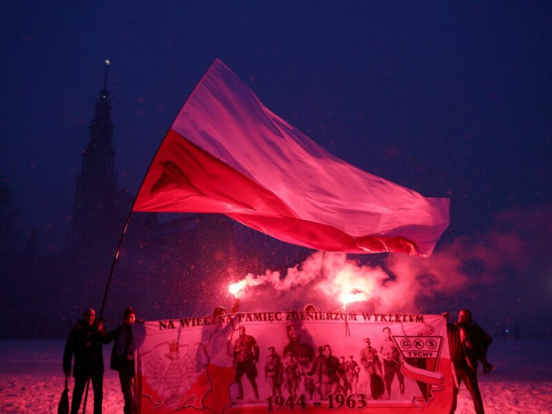 Polish football fans seen with the Polish flag and a banner commemorating the Cursed Soldiers (Zolnierze Wykleci) during the Patriotic Pilgrimage of Supporters to Jasna Gora (Czestochowa) with a light race
