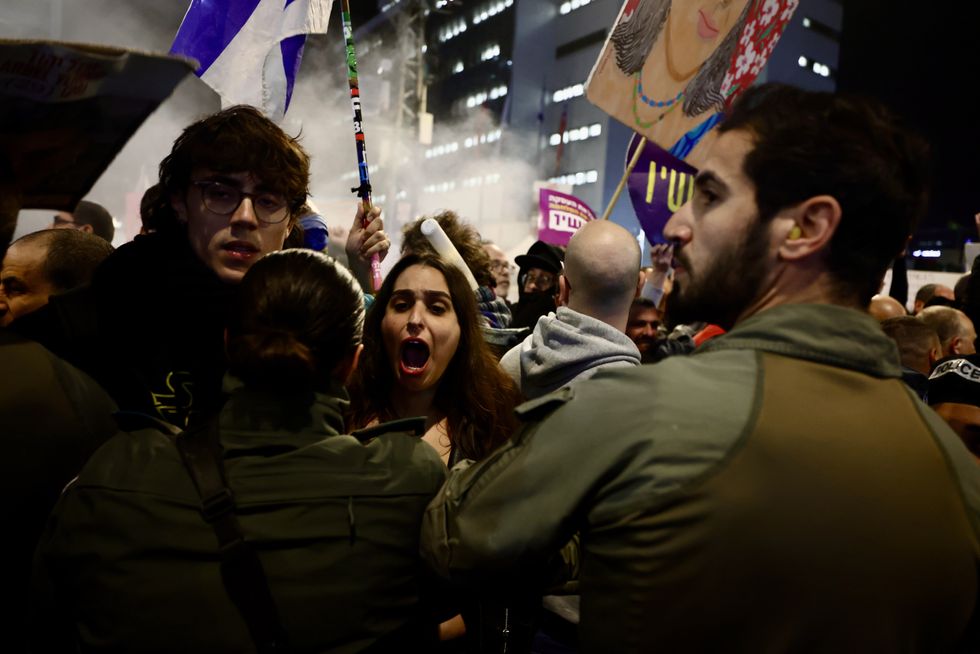 Protesters holding Israeli flags and homemade posters clash with police.