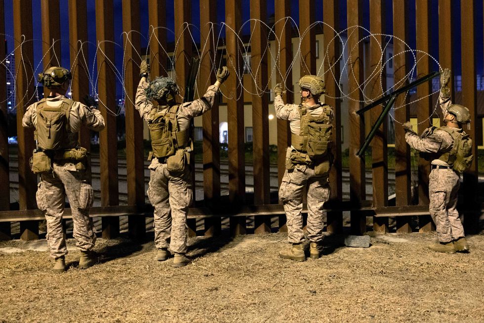 U.S. Marines re-enforce the border wall in San Ysidro, California, with concertina barbed wire.