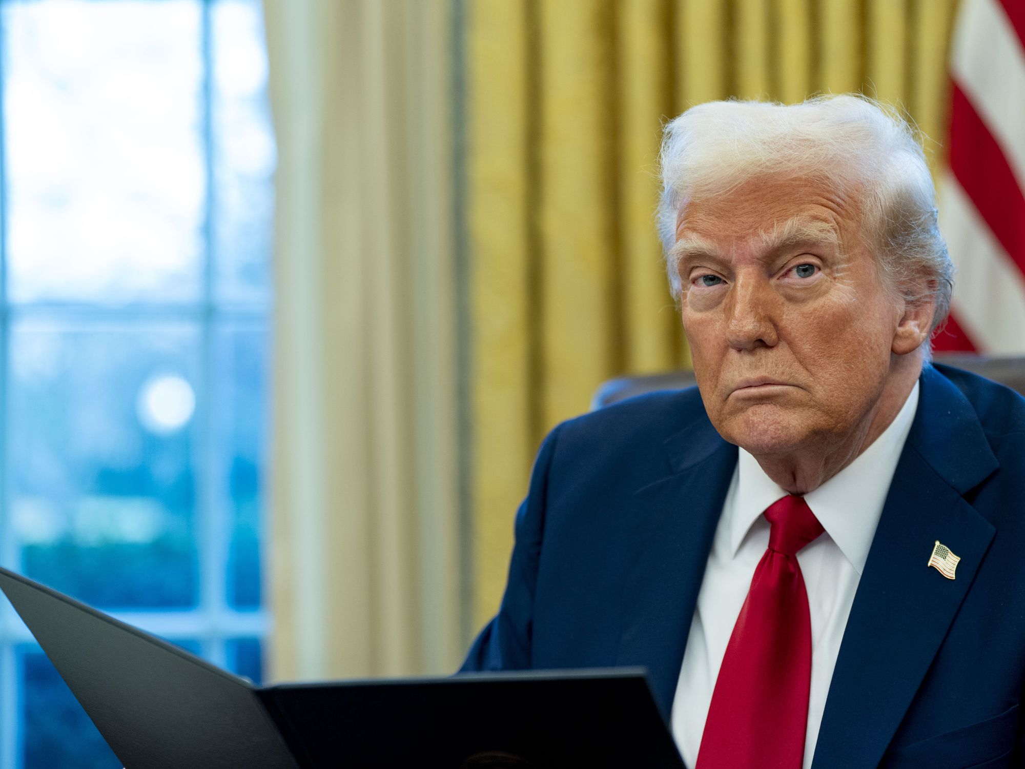 United States President Donald Trump signs two executive orders in the Oval Office of the White House in Washington, DC