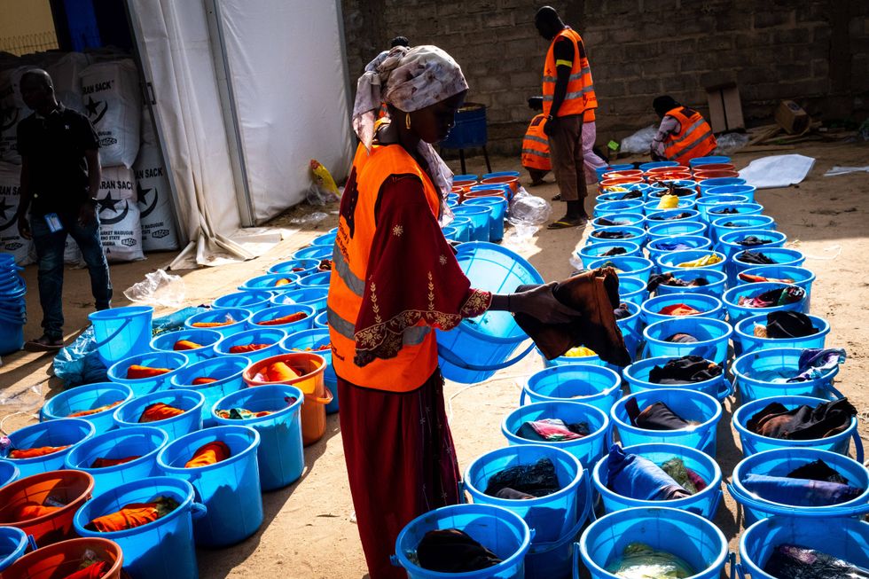 Woman daily worker preparing hygiene kits at the warehouse of Atlas Logistique