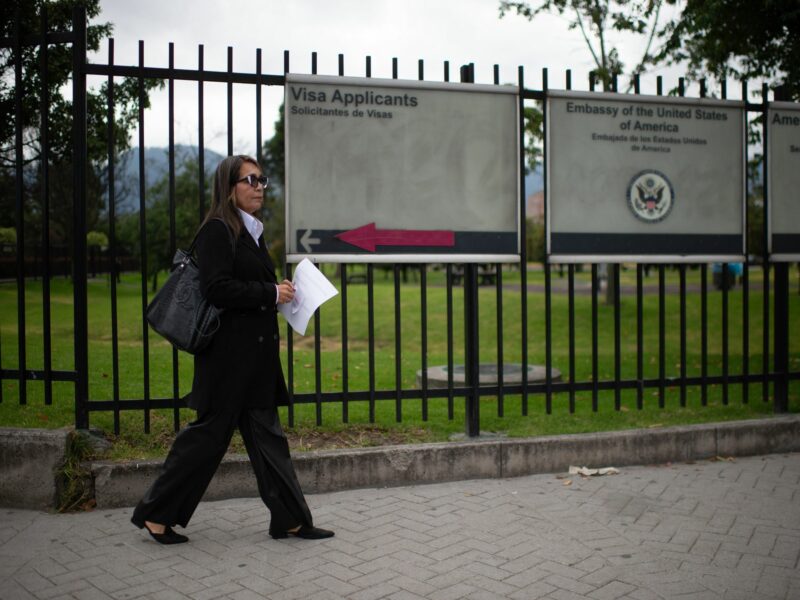 woman waiting outside US embassy in Bogota, Colombia.