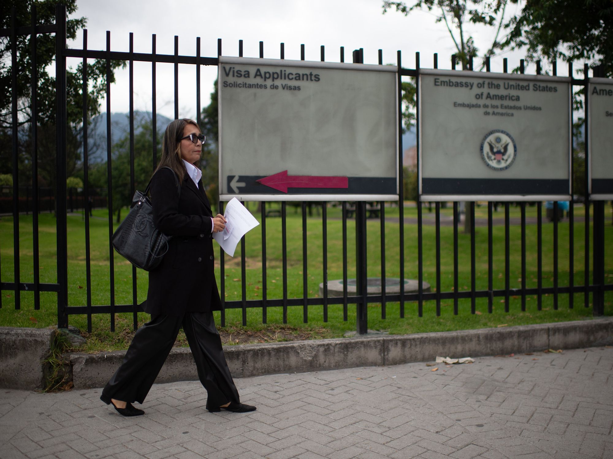 woman waiting outside US embassy in Bogota, Colombia.