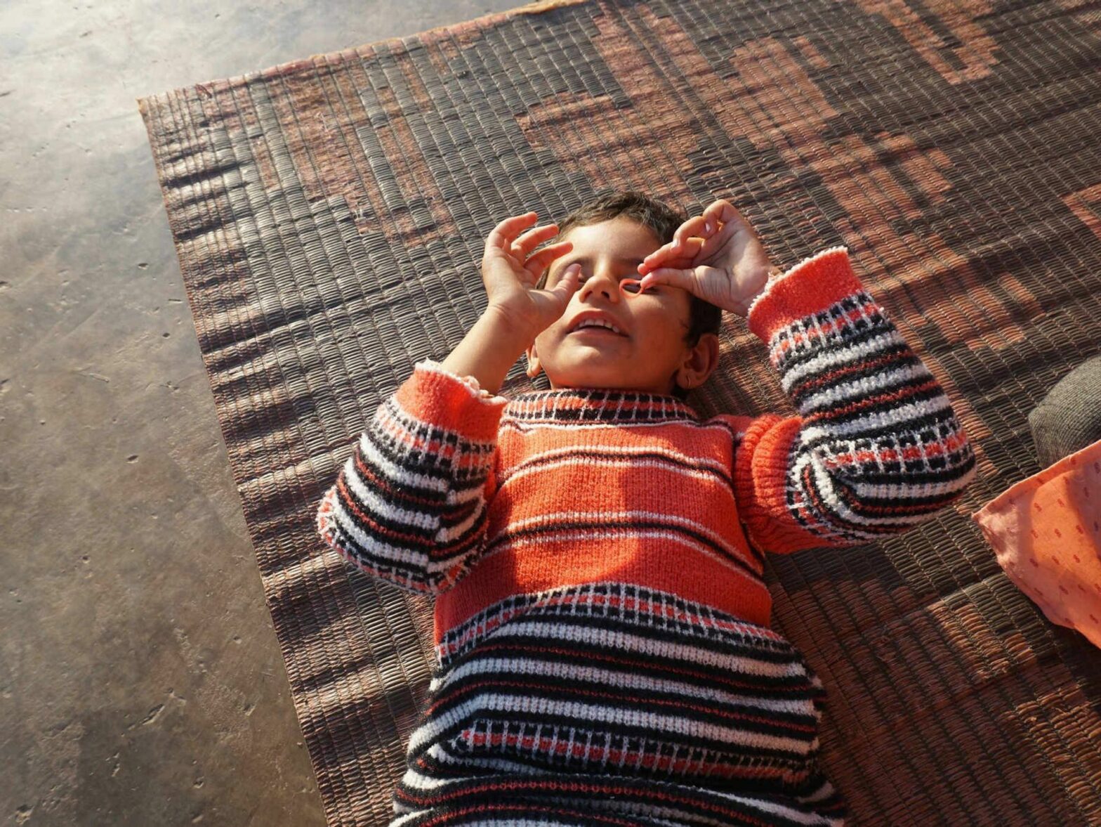 A 6-year-old girl plays on the ground.