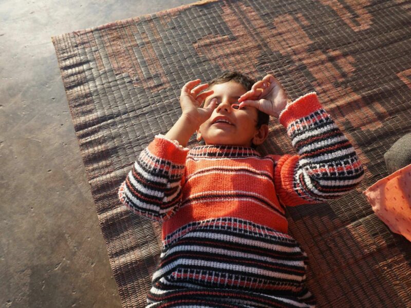 A 6-year-old girl plays on the ground.
