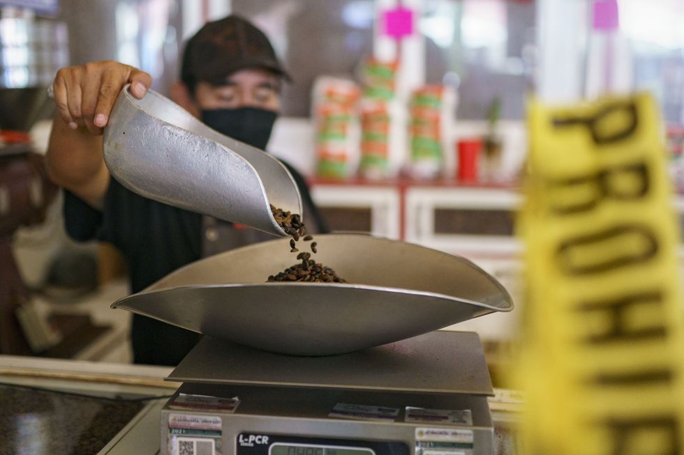 A barista weighs coffee grains at Cafe Equis, the oldest coffee shop in Mexico city.