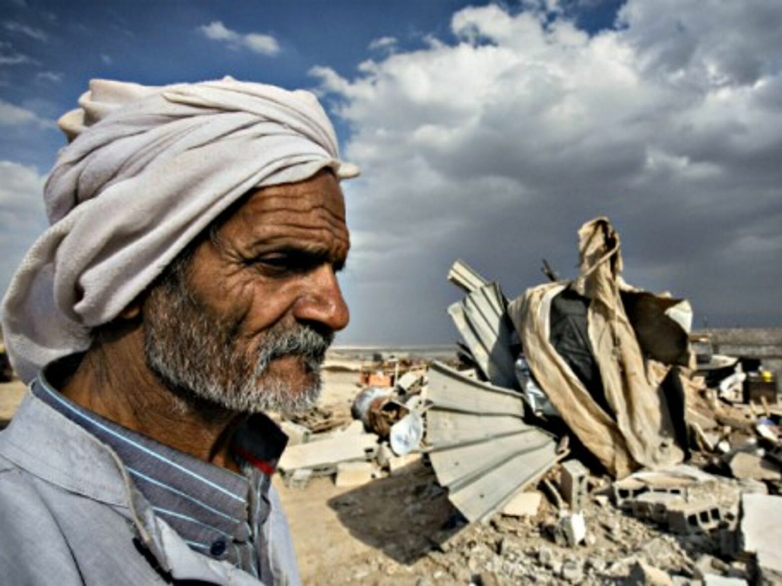 A Bedouin elder in the ruins of his home