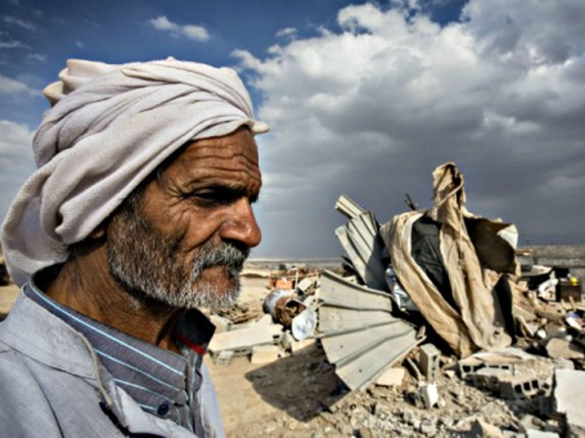A Bedouin elder in the ruins of his home