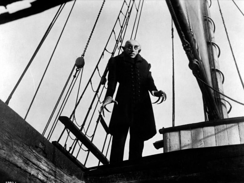 A black and white still from the German film Nosferatu, showing the vampire aboard a ship.